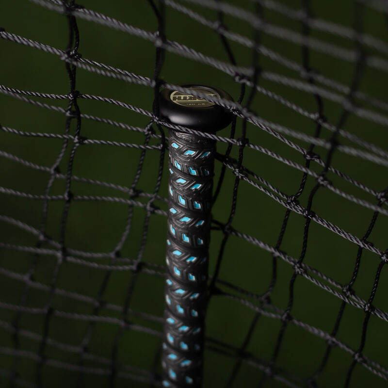 Black handle of a KReCHeR USSSA softball bat in a batting cage - SKU: WSU3KRL loading=