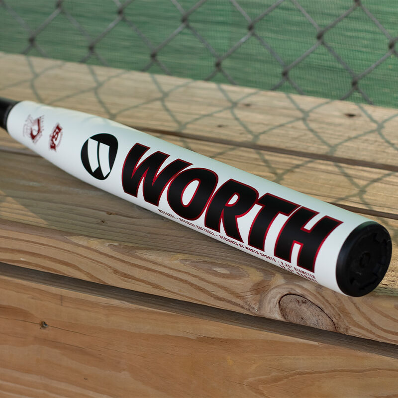 Worth logo on the barrel of a KReCHeR Gamer Series senior bat sitting on a bench in a dugout - SKU: WSS4KGL
